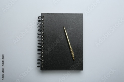 One notebook and pen on light grey background, top view