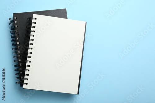 Notebooks on black background, top view. Space for text