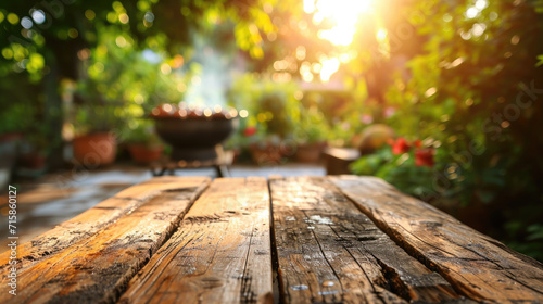 Close-up of a rustic wooden table top with a blurred background of a garden and warm sunlight filtering through the leaves. photo
