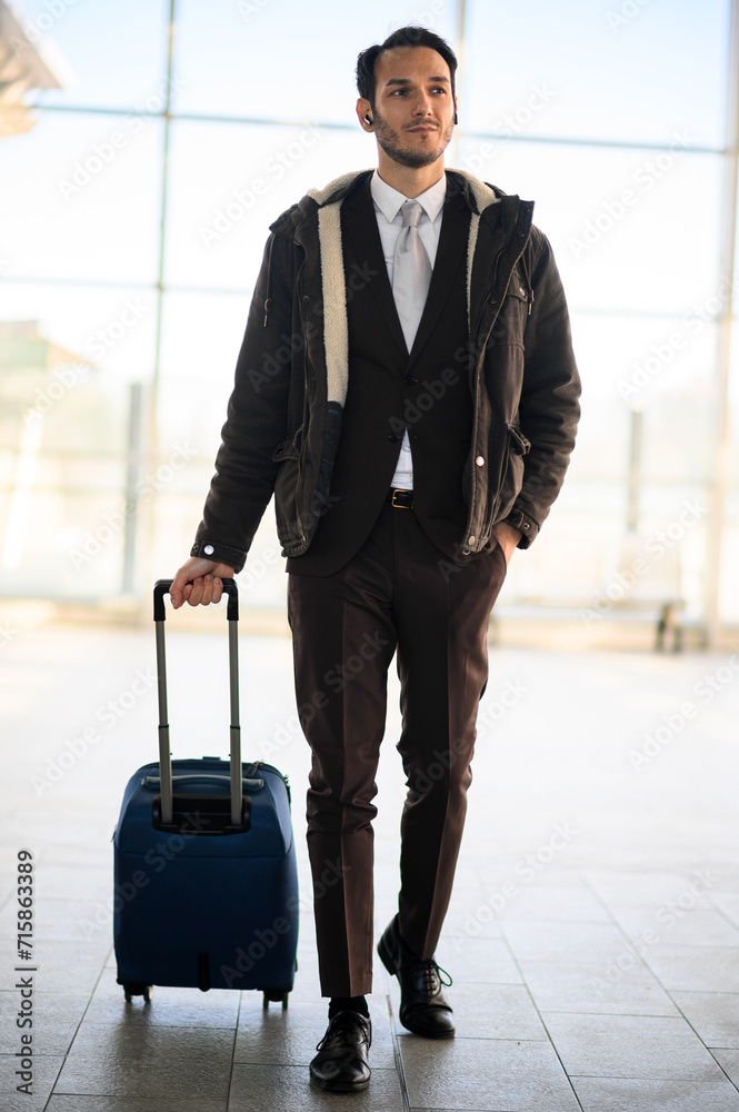 Confident businessman with luggage at airport Confident businessman with luggage at airport
