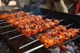 Grilled spicy chicken seek kababs on metal skewers are sold as street food in Old Delhi market, known for its spicy non-vegetarian dishes.