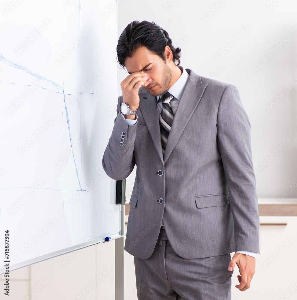 Young handsome businessman in front of whiteboard Young handsome businessman in front of whiteboard