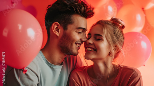 Beautiful young couple celebrating valentines day with balloons on color background