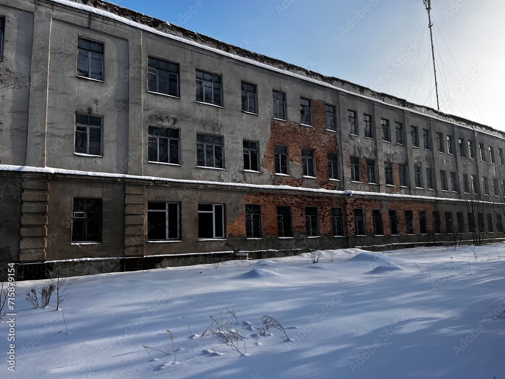 Old abandoned factory building in winter.