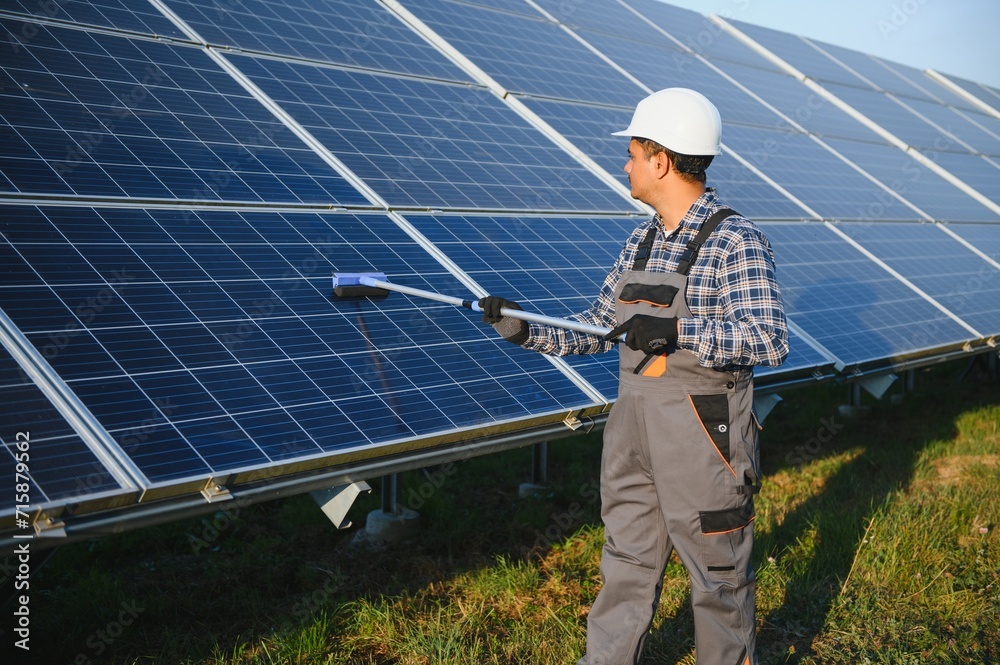 Indian worker cleaning solar panels Indian worker cleaning solar panels