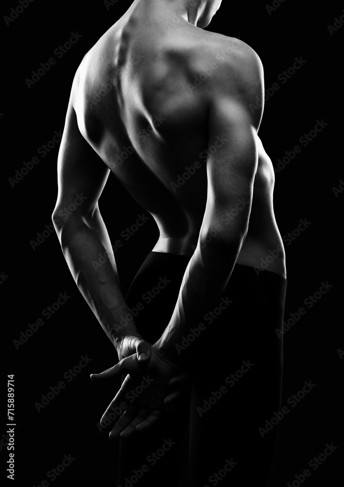 Naklejka premium Silhouette of a slender muscular man doing sports in the gym. Sports and healthy lifestyle.