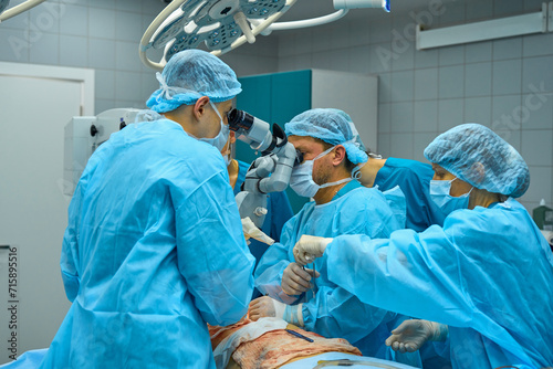 Plastic surgeons perform surgery on a patient