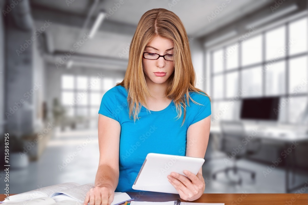 Young business woman checking bills at work in office Young business woman checking bills at work in office