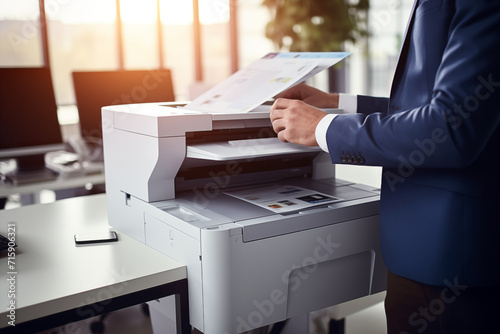 Businessman print paper on a multifunction laser printer in business office. Document and paperwork. Secretary work. Copy, print, scan, and fax machine. Print technology. Photocopy. photo