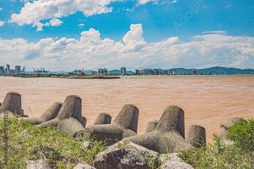 mole of Itajaí with the city of Itajai in the background, dirty water of the Itajai Açu river
