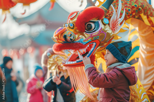 A child celebrating at the Chinese New Year of the Dragon celebration .