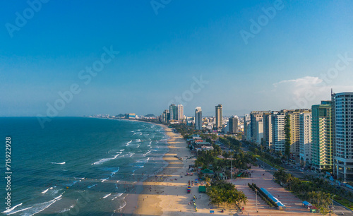 Aerial sunset view of Da Nang coastline. My Khe beach seafront with high-rise hotels and skyscrapers in the golden sand beach photo