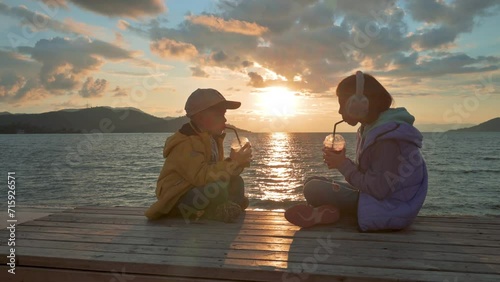 Boy and girl drinking juice in the evening. 4k slow motion footage UHD 3840x2160 