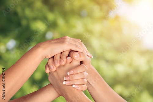 group of people hold hands together for support