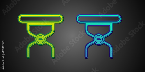 Green and blue Camping portable folding chair icon isolated on black background. Rest and relax equipment. Fishing seat. Vector