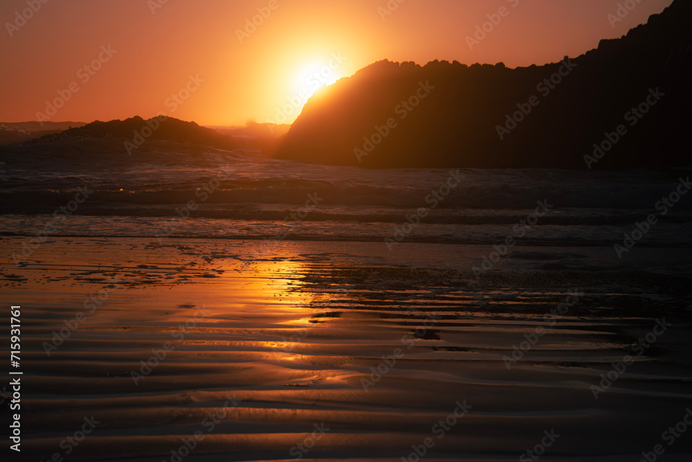 Sunset over the Pacific Ocean at South Seal Point, where the cliff meets the ocean waves. Sunset over the Pacific Ocean at South Seal Point, where the cliff meets the ocean waves.