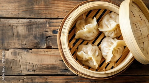 Momo dumplings in a bamboo steamer. Wooden background. Top view photo