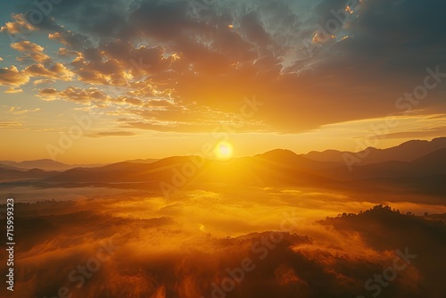 Misty mountains in the warm glow of a golden dawn © BraveSpirit