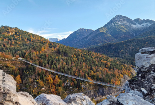 Views of a really long suspension bridge over a very high valley in the Alps
