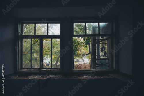 an abandoned broken windows. Old destroyed houses. Broken glass in the window. War, destruction, restructuring. abandoned, useless houses. Consequences of social and economy problems. Empty house photo