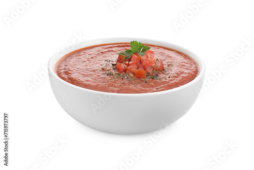 Delicious tomato cream soup with spices in bowl isolated on white