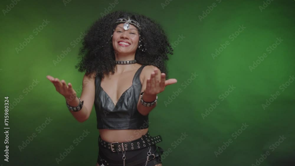 Black Brazilian woman, in black carnival clothes, inviting with her hands.
