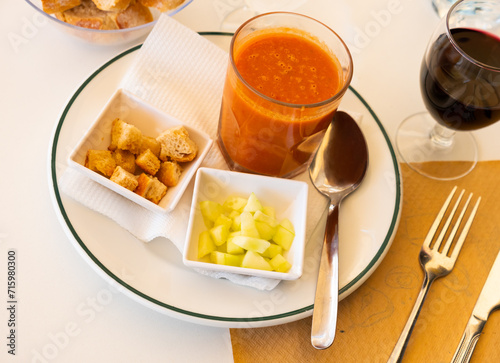 Traditional Spanish dish Gazpacho, made from tomato puree, is served with croutons and sliced cucumber