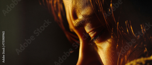 a closeup profile of a woman's expressive face with her eyes closed