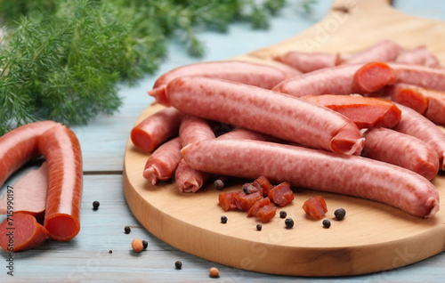 raw sausages on wooden board, Sliced half-smoked sausages on wooden table. Traditional Chezh meat products. photo