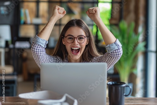 Woman Working on Laptop With Raised Arms