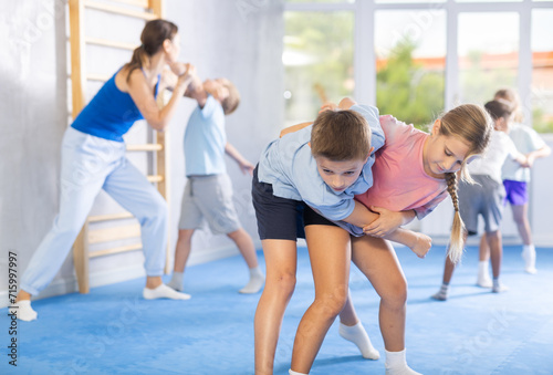 Young jiu jitsu students are fine-tuning their striking techniques in dojo.