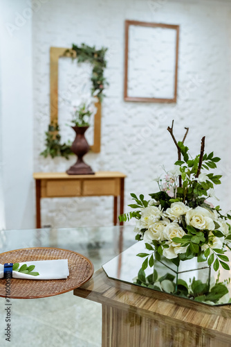 white wall with a wooden frame and flower decorations