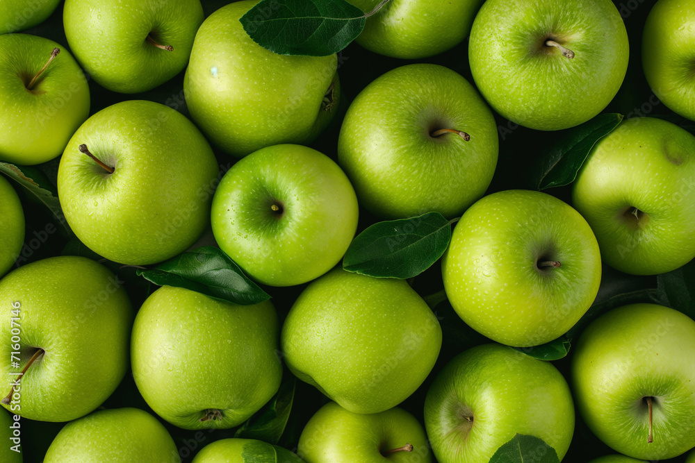lots of green apples with leaves lying on top of each other, for background, top view lots of green apples with leaves lying on top of each other, for background, top view