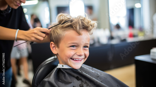 happy smiling child sitting in a chair at the hairdresser, haircut, hairstyle, style, girl, boy, kid, toddler, fashion, beauty salon, barbershop, hair, portrait, face, emotional