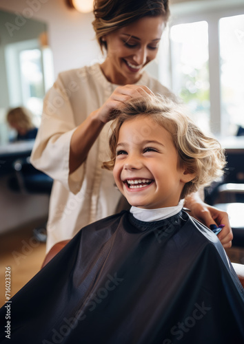 happy smiling child sitting in a chair at the hairdresser, haircut, hairstyle, style, girl, boy, kid, toddler, fashion, beauty salon, barbershop, hair, portrait, face, emotional