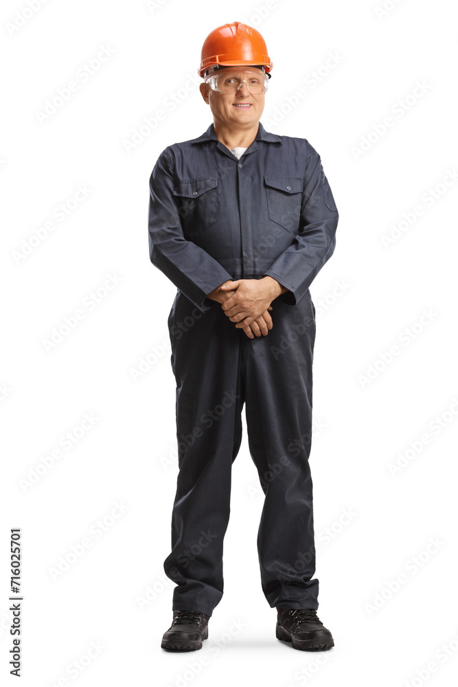 Male factory worker in overall uniform and orange helmet Male factory worker in overall uniform and orange helmet