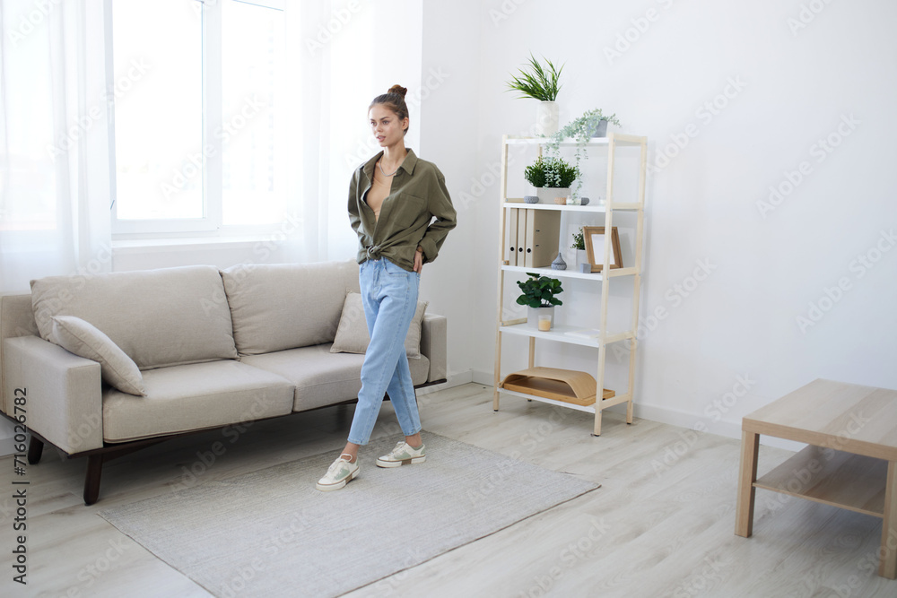 Joyful Woman Jumping and Dancing with Music in a Playful Indoor Apartment