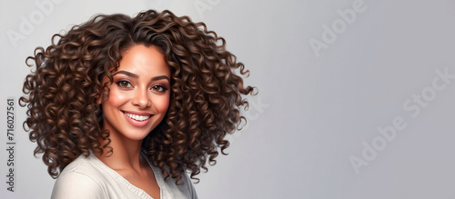 Woman with curly hair on white background.
