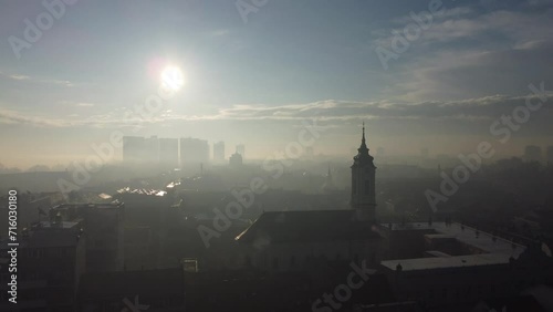 Drone flight above the church in the smog and fog in the morning. Zemun and New Belgrade district, Belgrade, Serbia, Europe. photo