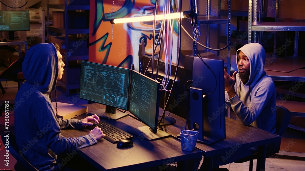 Jib up shot of hackers creating pirating crack for software and video game releases, getting past anti tamper measures implemented by companies trying to protect their products Jib up shot of hackers creating pirating crack for software and video game releases, getting past anti tamper measures implemented by companies trying to protect their products