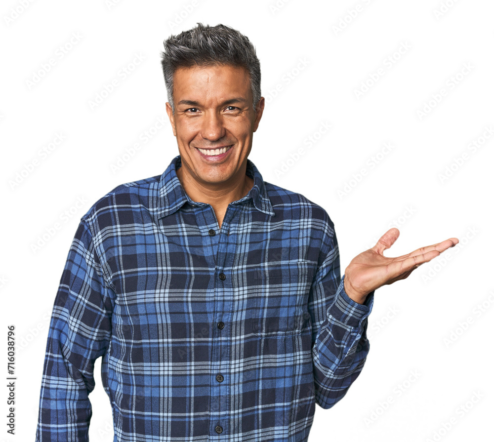Middle-aged Latino man showing a copy space on a palm and holding another hand on waist. Middle-aged Latino man showing a copy space on a palm and holding another hand on waist.
