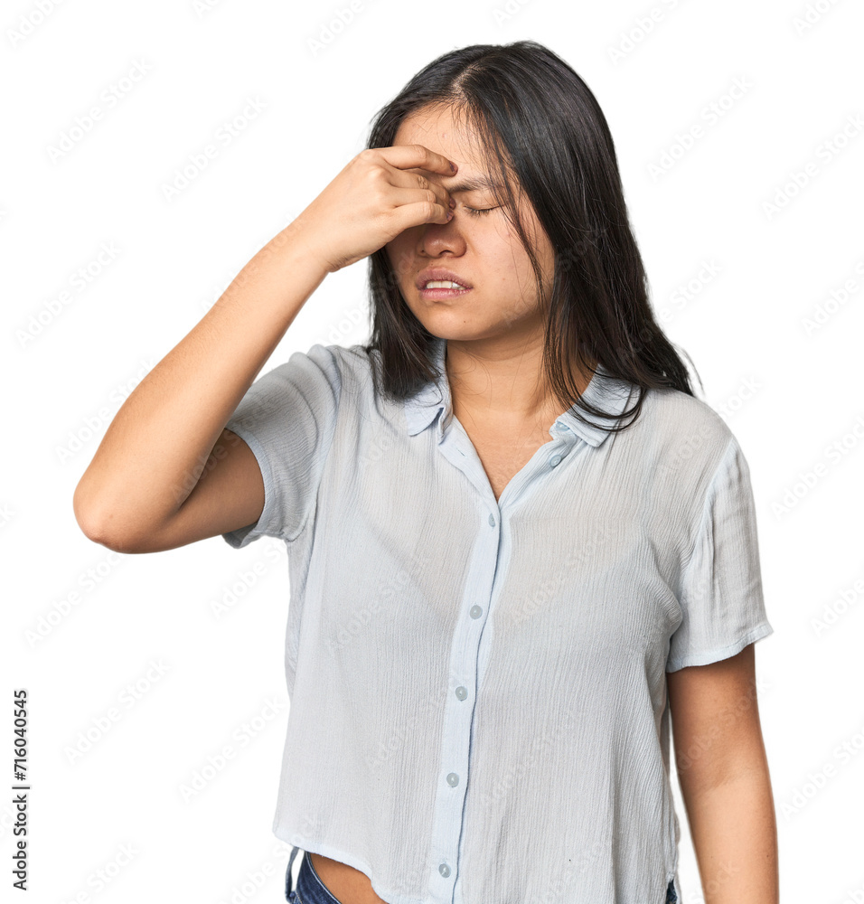Young chinese woman isolated having a head ache, touching front of the face. Young chinese woman isolated having a head ache, touching front of the face.