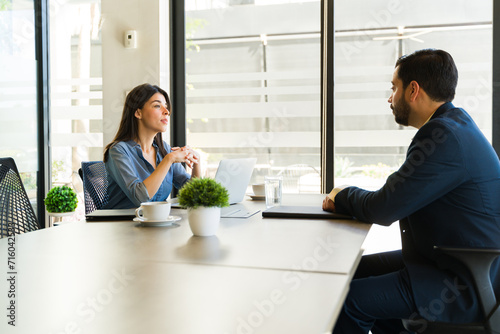 Profile view of a woman talking to a job candidate during an interview photo