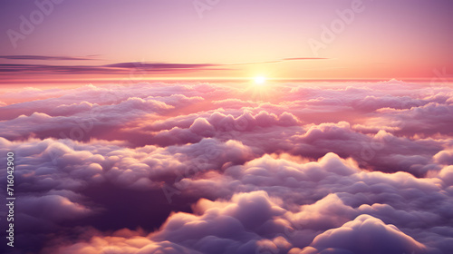a sunset and the sun is rising over clouds