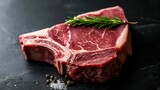 Raw meat steak with seasoning on concrete background. Beef T-bone steak, top view. Barbecue concept. Ingredients for roasting meat.