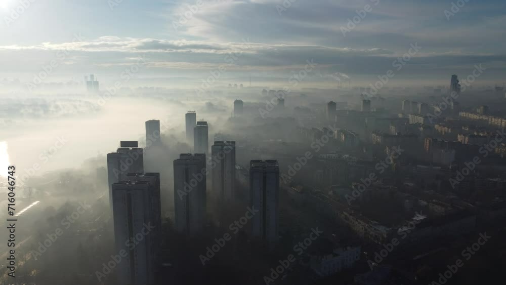 Drone flight above Belgrade city in the smog and fog in the morning. Zemun and New Belgrade district, Serbia, Europe.