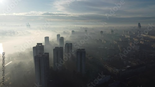 Drone flight above Belgrade city in the smog and fog in the morning. Zemun and New Belgrade district, Serbia, Europe. photo