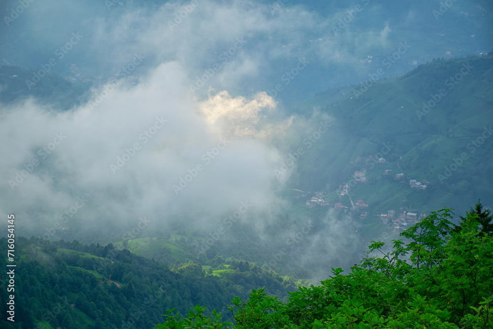 Sunset casts final beams of light on the Plateau as a storm looms. A village in the fog on the plateau.