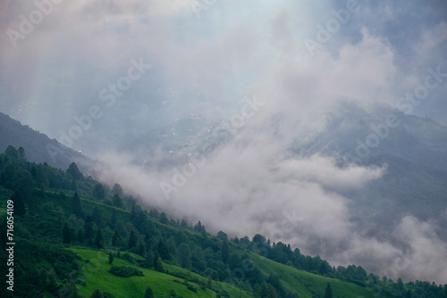 Sunset casts final beams of light on the Plateau as a storm looms. A village in the fog on the plateau.