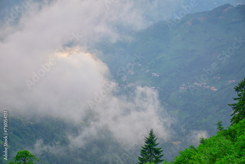 Sunset casts final beams of light on the Plateau as a storm looms. A village in the fog on the plateau.